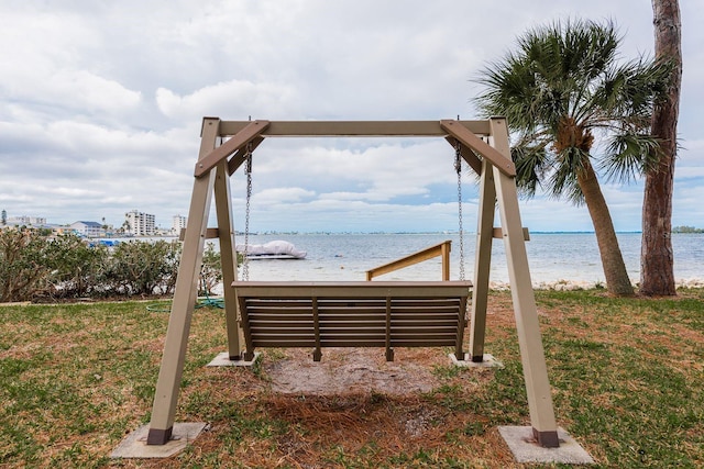 exterior space with a water view and a lawn