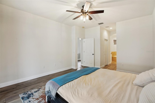 bedroom featuring ceiling fan, wood finished floors, visible vents, and baseboards