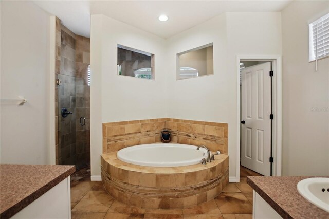 full bath featuring a bath, a stall shower, and vanity