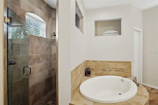 full bathroom featuring a stall shower and a garden tub