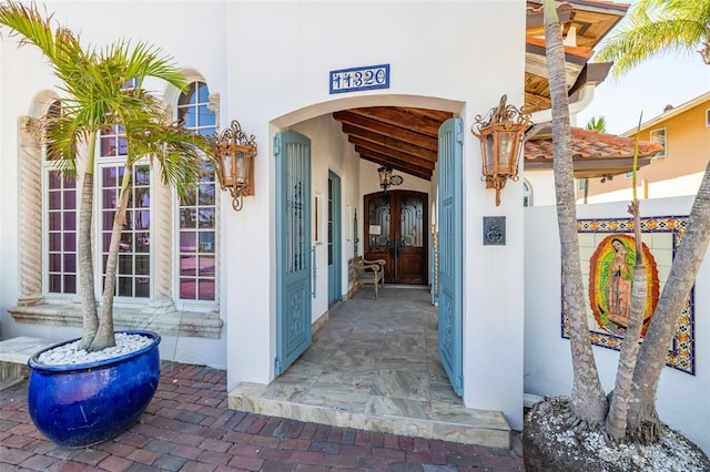 entrance to property featuring stucco siding