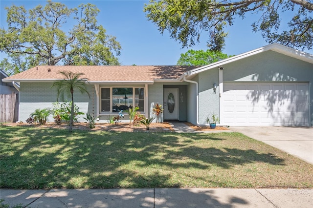 ranch-style home with a front yard, fence, concrete driveway, a garage, and brick siding