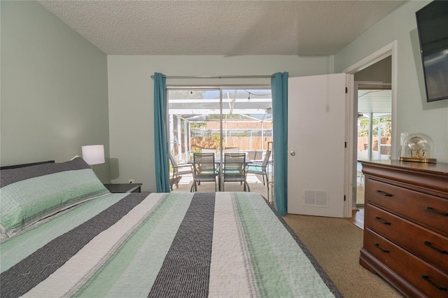 carpeted bedroom with access to exterior, visible vents, multiple windows, and a textured ceiling