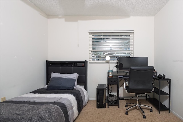 carpeted bedroom featuring baseboards and a textured ceiling