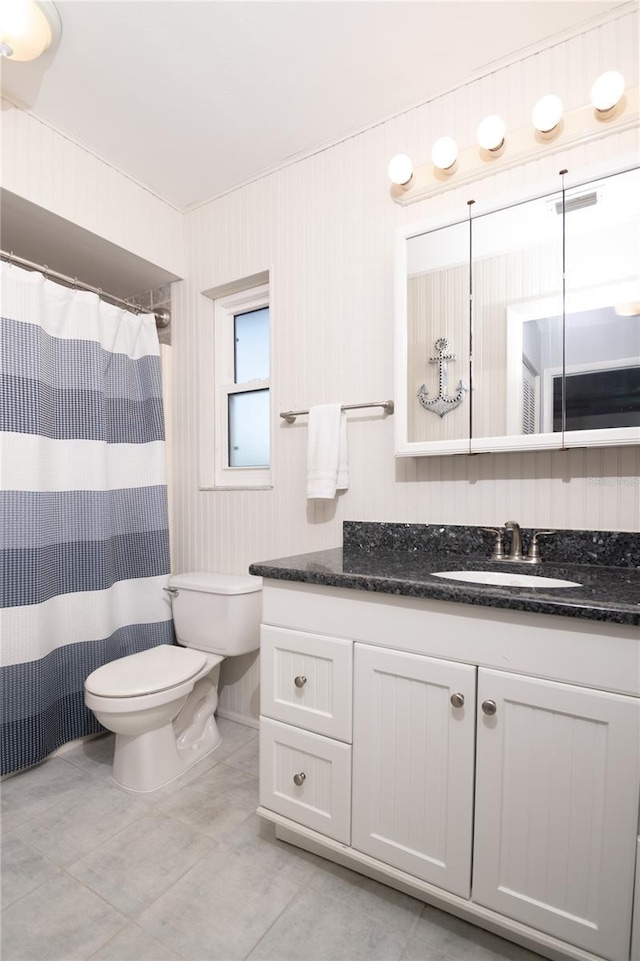 bathroom with tile patterned floors, curtained shower, toilet, and vanity