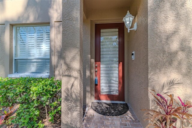 property entrance featuring stucco siding