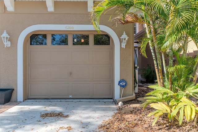 garage featuring concrete driveway