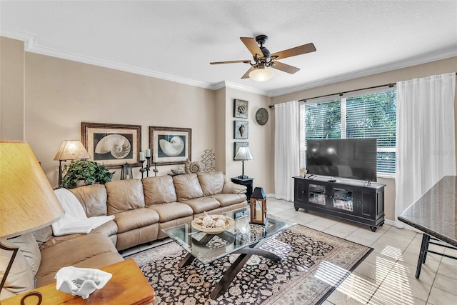 tiled living room featuring a textured ceiling, ornamental molding, a ceiling fan, and baseboards