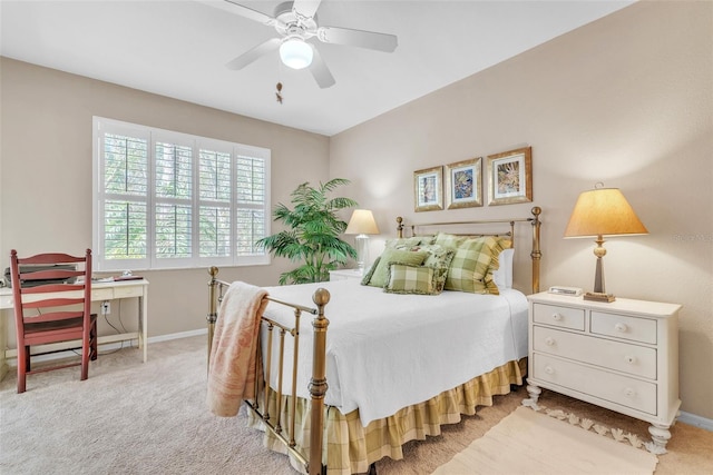 bedroom with ceiling fan, baseboards, and light colored carpet