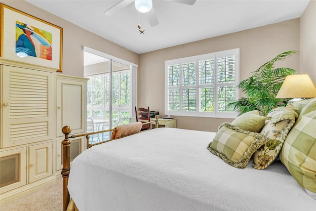 carpeted bedroom with access to exterior and ceiling fan