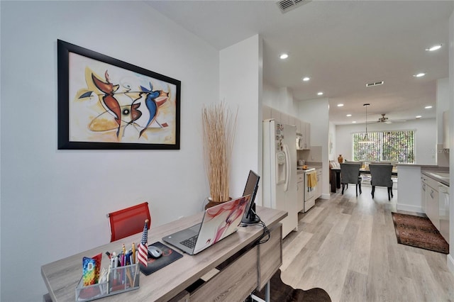 office space featuring light wood-style flooring, recessed lighting, and visible vents