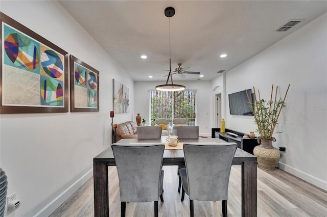 dining room featuring light wood-type flooring, visible vents, baseboards, and recessed lighting