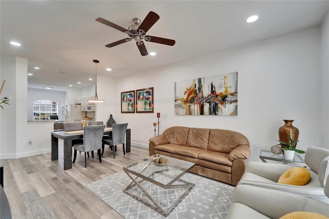 living room with recessed lighting, baseboards, a ceiling fan, and light wood finished floors