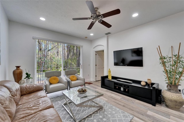 living room with recessed lighting, visible vents, a textured ceiling, and wood finished floors