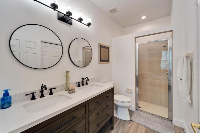 bathroom with a sink, visible vents, toilet, and a stall shower