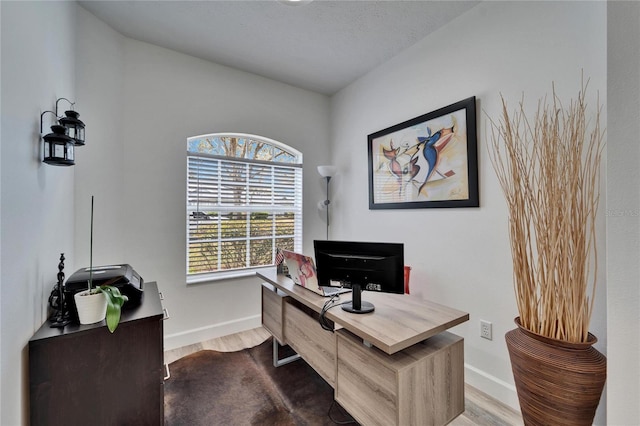 office area with baseboards and wood finished floors