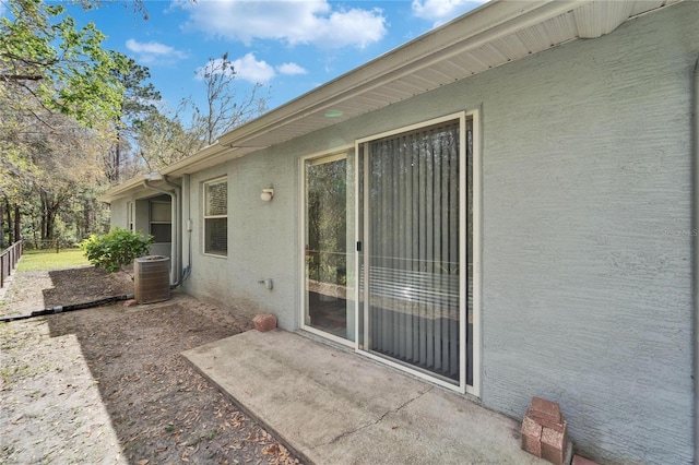 view of patio with fence and central AC