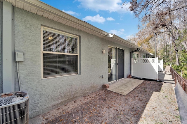 view of patio featuring central AC and fence