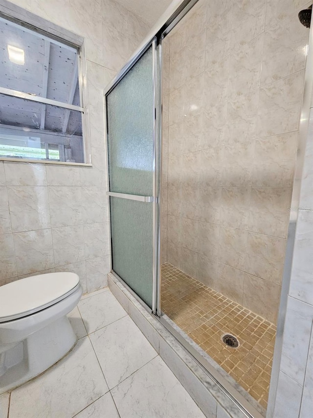 full bathroom featuring a stall shower, marble finish floor, and toilet