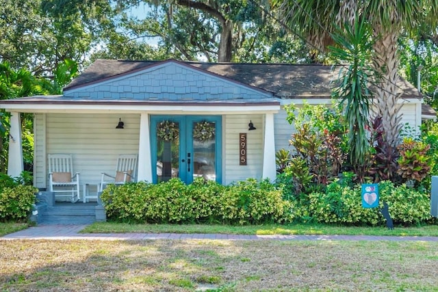 view of front of house with french doors and a front yard