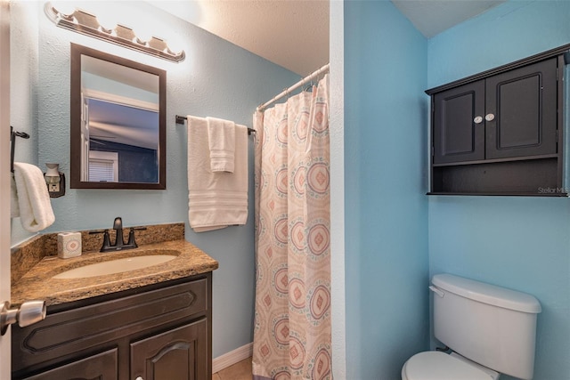 bathroom with toilet, a shower with shower curtain, and vanity