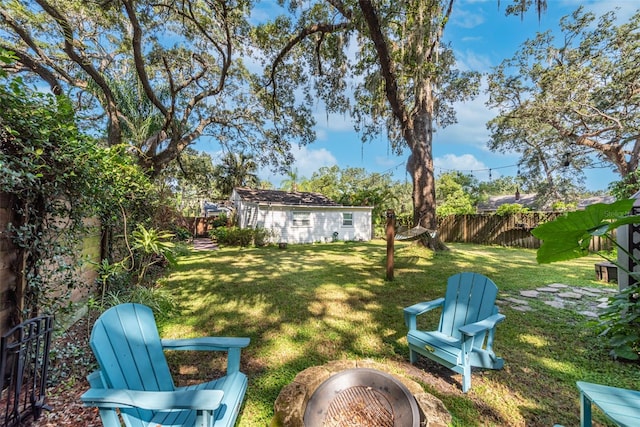 view of yard with a fenced backyard and an outdoor structure