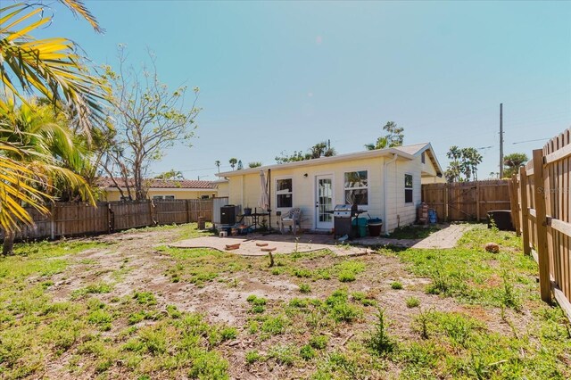 back of house featuring a patio and a fenced backyard