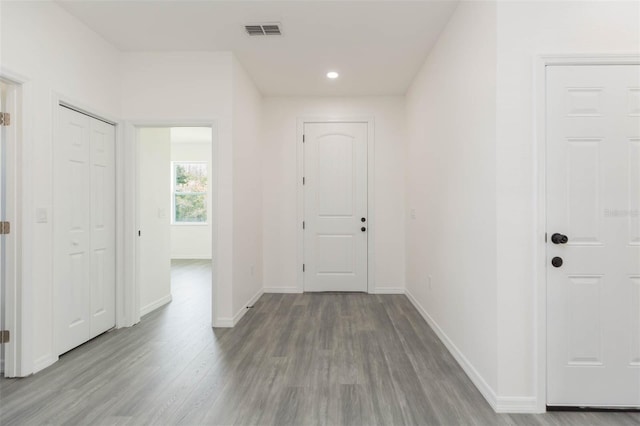 foyer featuring recessed lighting, visible vents, baseboards, and wood finished floors