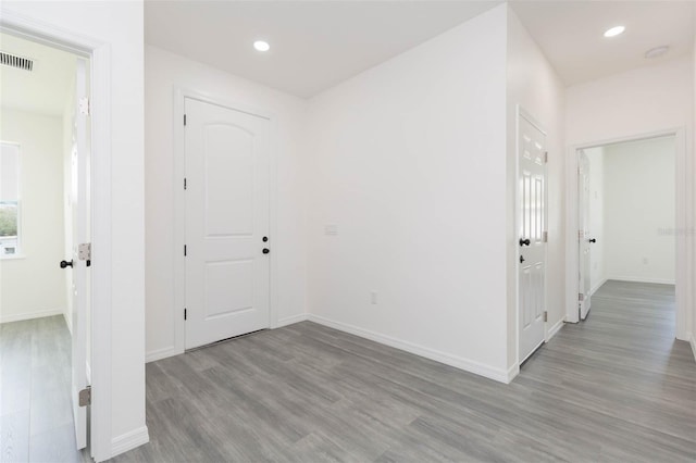 foyer featuring recessed lighting, visible vents, light wood-style flooring, and baseboards