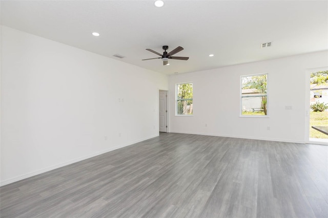 spare room featuring recessed lighting, visible vents, and wood finished floors