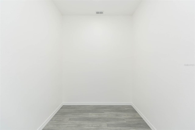 interior space featuring light wood-type flooring, visible vents, and baseboards