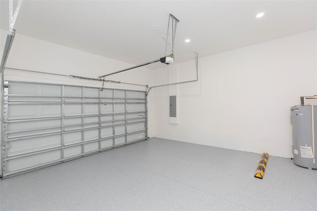 garage with a garage door opener, recessed lighting, electric panel, and electric water heater