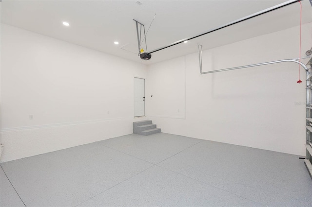 garage featuring recessed lighting and a garage door opener