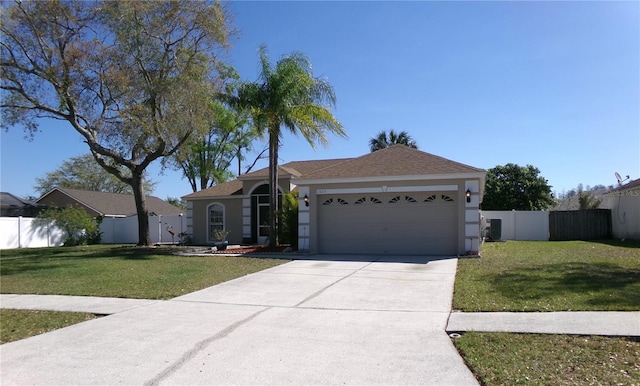 single story home featuring a front lawn, fence, stucco siding, driveway, and an attached garage