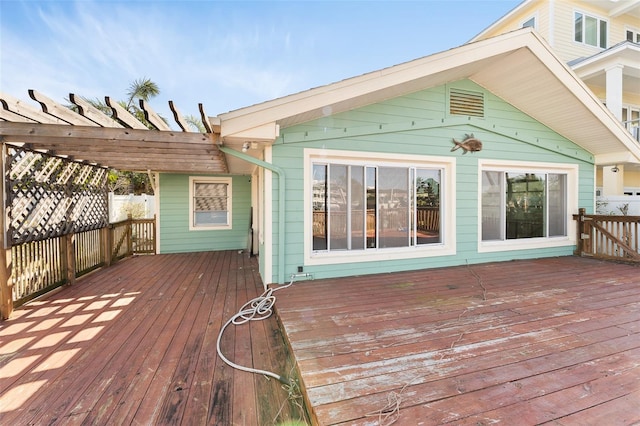 wooden terrace featuring fence and a pergola