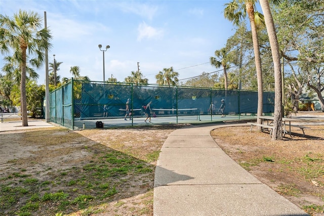 view of tennis court featuring fence