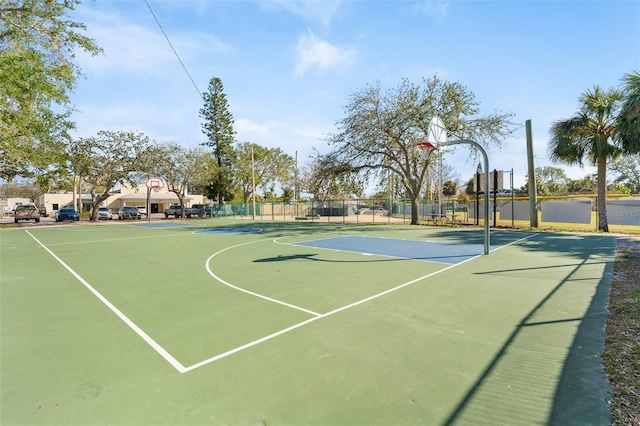 view of basketball court with community basketball court and fence