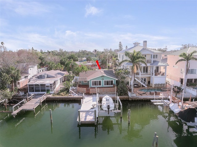 dock area featuring stairway, a residential view, a water view, and boat lift