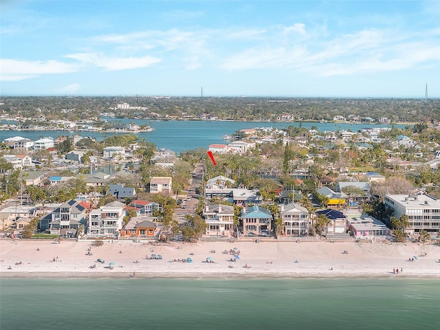 birds eye view of property with a water view and a beach view