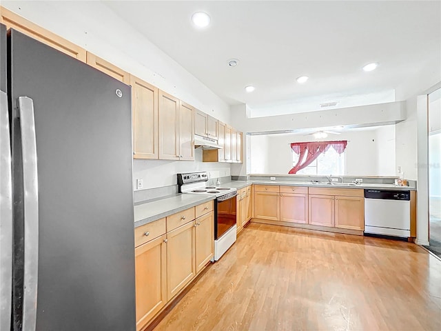 kitchen with light brown cabinetry, a sink, light wood-type flooring, white appliances, and under cabinet range hood