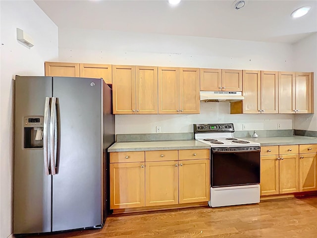 kitchen with stainless steel fridge, light wood-style floors, electric stove, light countertops, and under cabinet range hood