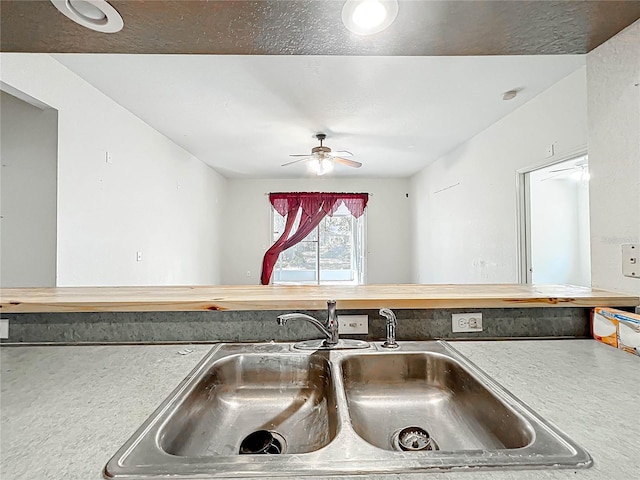 room details featuring a ceiling fan and a sink