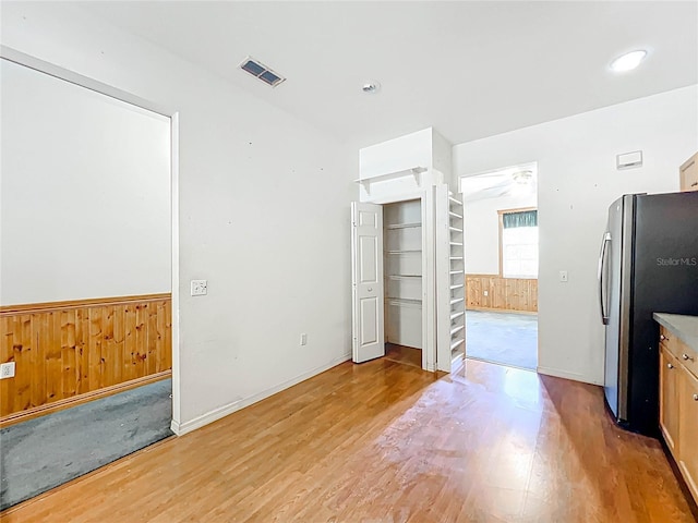 interior space with light wood finished floors, recessed lighting, visible vents, a ceiling fan, and freestanding refrigerator