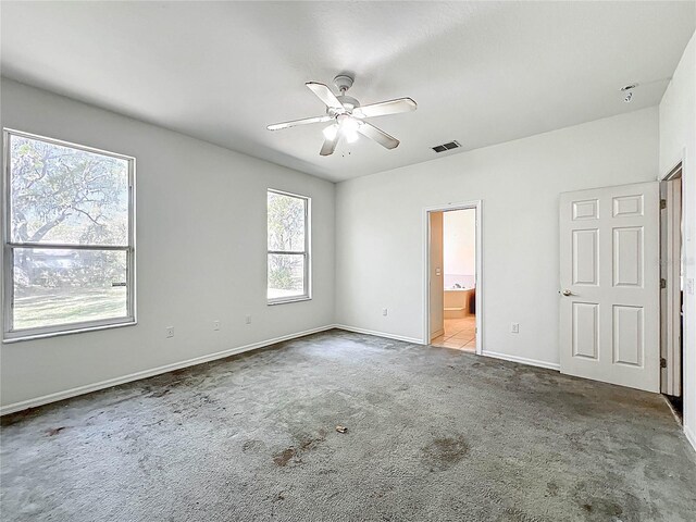 unfurnished bedroom with carpet, visible vents, a ceiling fan, connected bathroom, and baseboards