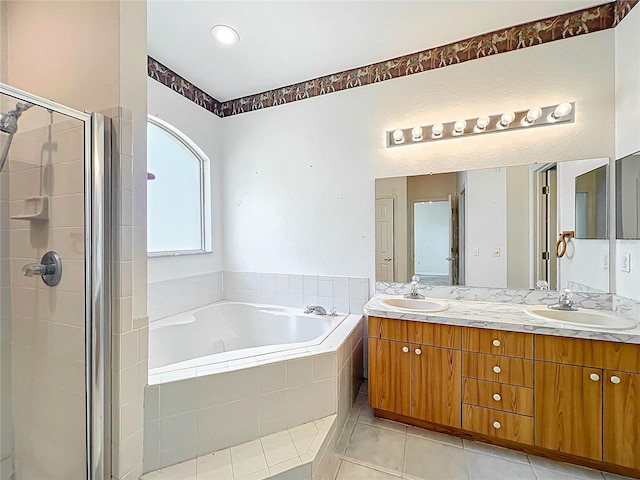 full bathroom with a garden tub, tile patterned flooring, a sink, and a shower stall