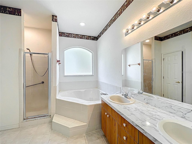 full bath with a sink, tile patterned flooring, a shower stall, and a bath