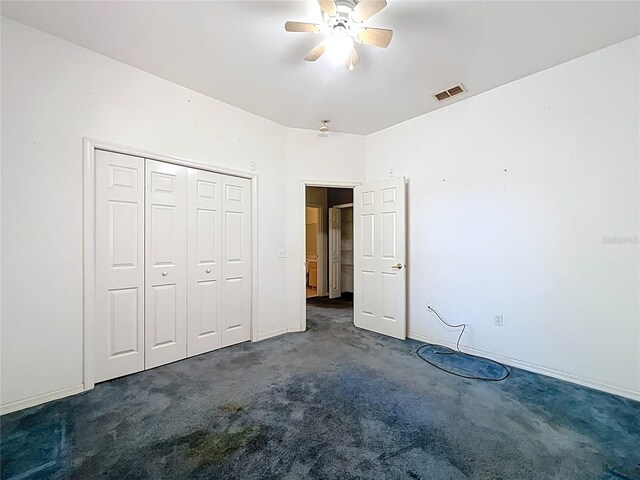 unfurnished bedroom featuring baseboards, visible vents, a ceiling fan, carpet flooring, and a closet