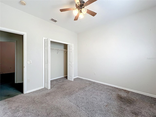 unfurnished bedroom featuring baseboards, visible vents, a ceiling fan, carpet flooring, and a closet