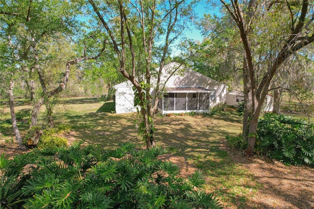 view of yard with a sunroom