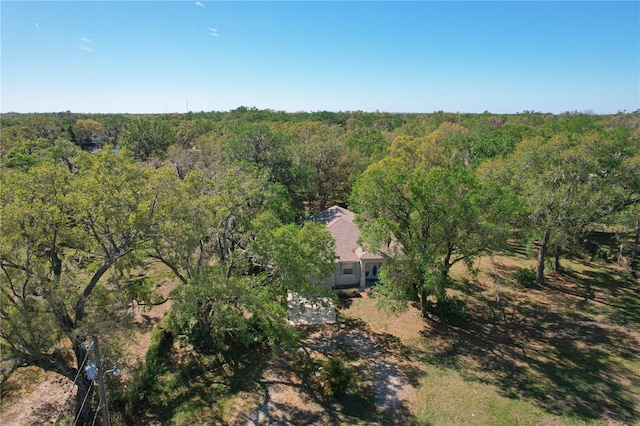 birds eye view of property with a view of trees